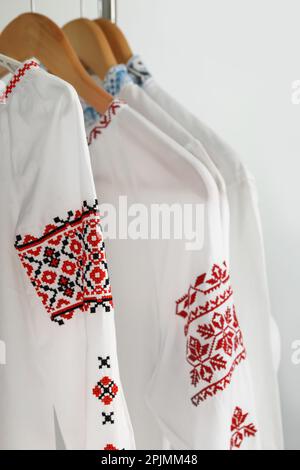 Beautiful shirts with different embroidery designs on white background. Ukrainian national clothes Stock Photo