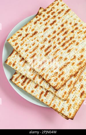 Traditional Jewish food matzo bread on pink background. Happy Passover. Religious spring holiday Pesach. Stock Photo