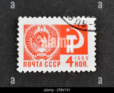 Cancelled postage stamp printed by Soviet Union, that shows Coat of Arms of the USSR, Hammer and Sickle, circa 1966. Stock Photo