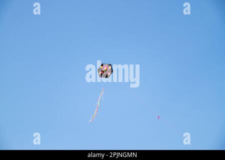 Kite with a pirate on it flying in a blue sky Stock Photo