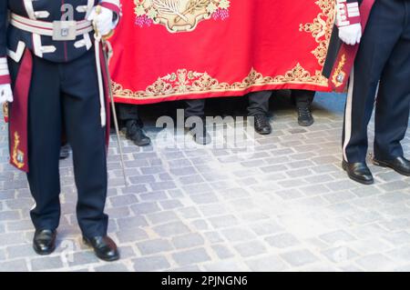 Feet of the pallbearers carrying the statue of  Jesus Christ La Borriquita on Palm Sunday  during the procession in Madrid, Spain. Stock Photo