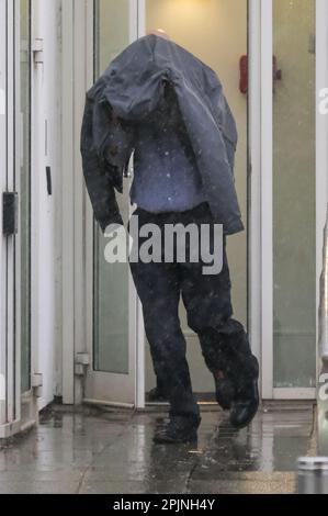 File photo dated 29/03/23 of civilian police worker Timothy Schofield, the brother of TV presenter Phillip Schofield, covering his head as he leaves Exeter Crown Court. Timothy Schofield has been found guilty of sexually abusing a teenage boy over a period of three years. Issue date: Monday April 3, 2023. Stock Photo