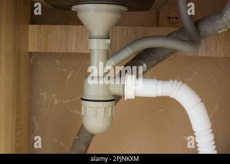 Siphon pipes under the kitchen sink in the kitchen Stock Photo
