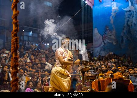 Ganga aarti, Portrait of an young priest performing river ganges evening aarti at Dashashwamedh Ghat in traditional dress with sanatan hindu rituals. Stock Photo