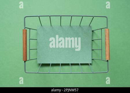 Empty basket with copy space on green background. top view Stock Photo