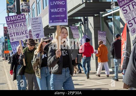 Detroit, Michigan, USA. 3rd Apr, 2023. Graduate student employees at the University of Michigan picket the university's Detroit Center during their strike for a living wage. The 2,000 members of the Graduate Employees Organization/AFT earn $24,000. They are asking for a living wage of $38,500. Credit: Jim West/Alamy Live News Stock Photo