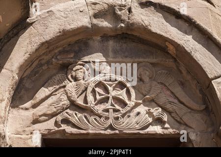 Stone carvings with cross. Exterior details of Jvari Monastery, it is a sixth-century Georgian Orthodox monastery located on the mountain peak near Mt Stock Photo