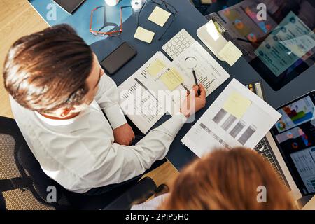 Business colleagues discussing financial data working together in office. People entrepreneurs working with charts and tables on computer. Two people Stock Photo