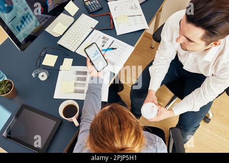 Business colleagues discussing financial data working together in office. People entrepreneurs working with charts and tables on computer and smartpho Stock Photo