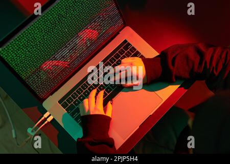 Anonymous people using computer and programming to break code. Cyber security threat. Internet and network security. Access to private information. An Stock Photo
