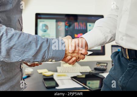 Handshake of business people. Man and woman shaking hands in office. Two people greeting at work. Collaborative teamwork Stock Photo