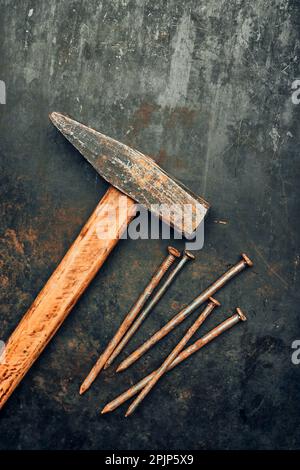 Hammer and nails on steel surface. Tools for maintenance. Hardware tools to fix. Technical background with copy space Stock Photo