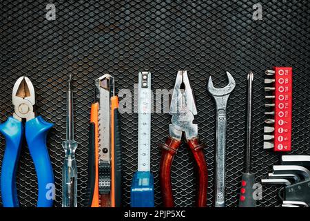 Hardware tools wrench screwdriver tape hammer on steel surface. Mechanic tools for maintenance. Hardware tools to fix. Technical background with copy Stock Photo