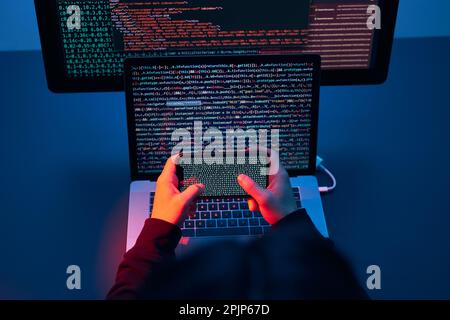 Man using computer and programming  to break code. Cyber security threat. Internet and network security. Stealing private information. Person using te Stock Photo