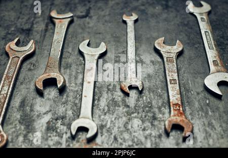 Spanners on steel surface. Old rusty wrenches for maintenance. Mechanic hardware tools to fix. Technical tools background with copy space Stock Photo