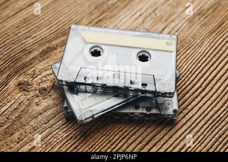 Tape cassettes. Magnetic cassette tapes on wooden table. Retro music style. 80s music party. Vintage style. Analog equipment. Stereo sound Stock Photo