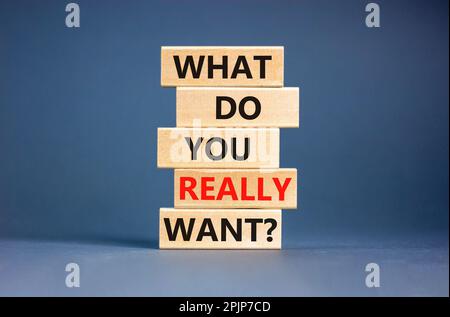 What do you really want symbol. Concept words What do you really want on wooden block. Beautiful grey table grey background. Business and what do you Stock Photo