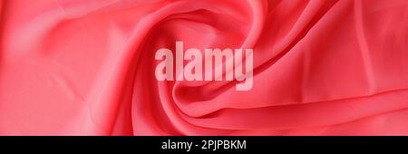 Macro texture of red fabric. Beautiful delicate pink satin fabric Stock Photo