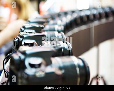 SLR digital cameras in a row Stock Photo