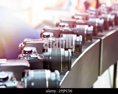 SLR digital cameras in a row Stock Photo