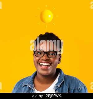 Cheerful millennial african american female in glass with abstract sun above head Stock Photo