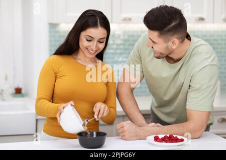 Beautiful middle eastern couple preparing breakfast together Stock Photo