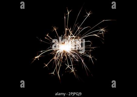 Burning sparkler isolated on black background. Fireworks theme. Light effect and texture. Christmas and new year decoration. Stock Photo