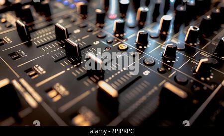 A detailed closeup of the knobs and buttons on a professional audio mixing console Stock Photo