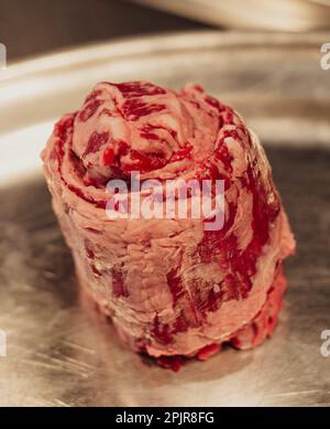 Raw beef meat on stainless steel plate. Selective focus. Toned. Stock Photo