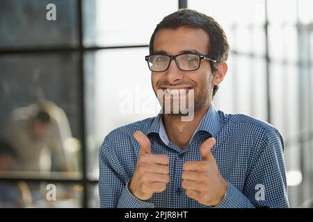Young businessman in casual wear approves positive hand gesture Stock Photo