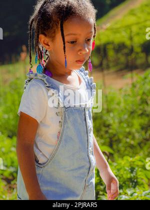 Portrait of african little girl walking in the farm vegetable garden