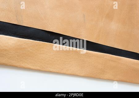 folded tan and brown leather on paper background Stock Photo