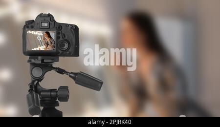 Young woman applying make up, selective focus on camera display Stock Photo