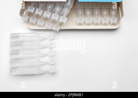 Single dose ampoules of sterile isotonic sea water solution on white background, top view Stock Photo