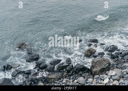 Aerial view coastal rocks with wave moving in the ocean Stock Photo