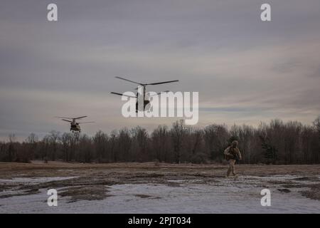 A U.S. Marine with 1st Battalion, 10th Marine Regiment, 2d Marine Division prepares to set security during exercise Rolling Thunder on Fort Drum, New York, March 27, 2023. This exercise is a live-fire artillery event that tested the 10th Marine Regiment’s ability to operate in a simulated littoral environment against a peer threat in a dynamic and multi-domain scenario. (U.S. Marine Corps photo by Lance Cpl. Averi Rowton) Stock Photo