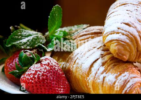 Croissant on the white plate, with fresh strawberry and whipped cream. High quality photo Stock Photo