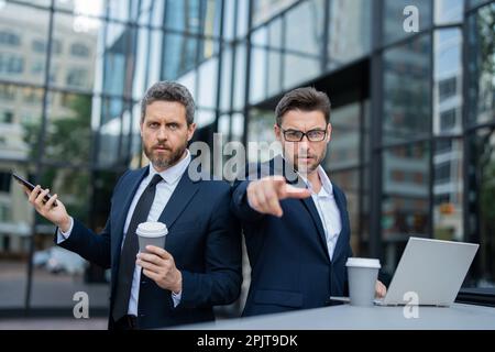 Risk management of the two business teams. Business men aggressive outdoor. Conflict and business concept. Colleagues aggressive disputing having Stock Photo