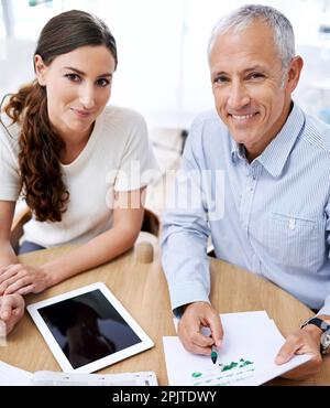 Confident in their business accumen. Portrait of two colleagues working together in the office. Stock Photo