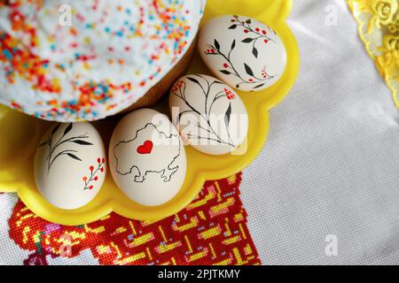 Easter kulich and decorated eggs on cloth, top view. Space for text Stock Photo