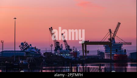 Leith Harbout, Edinburgh, Scotland, UK, 4th April 2023. UK Weather: gorgeous pre-dawn colours in the sky looking East over Leith docks with the ship Petrel seen still lying at a 45 degree angle in Imperial Dock. Credit: Sally Anderson/Alamy Live News Stock Photo