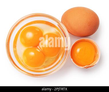 Brown chicken egg and egg yolks in glass bowl on white background. Clipping path. Stock Photo