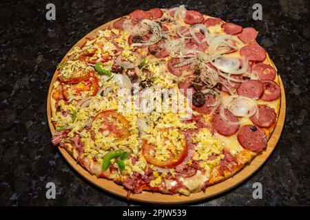 Traditional Brazilian pizza half Portuguese and half Calabrian Stock Photo