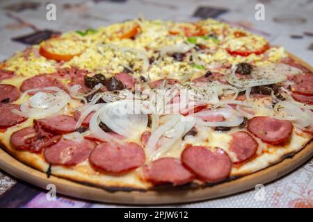 Traditional Brazilian pizza half Portuguese and half Calabrian Stock Photo