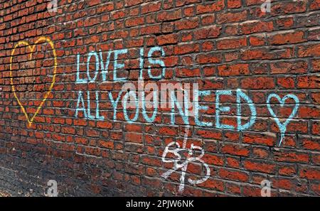 Love is all you need - Beatles lyric Graffiti on brick walls in Liverpool Stock Photo