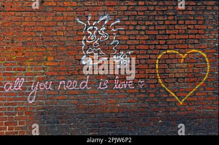 Beatles lyric Graffiti on brick walls in Liverpool - All you need is love Stock Photo