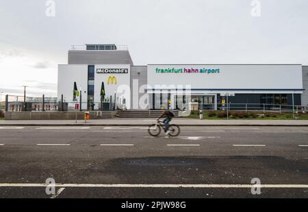 Lautzenhausen, Germany. 16th Feb, 2021. A cyclist rides past the terminal of 'Frankfurt Hahn Airport'. The hanging game around the insolvent Hunsrück Airport Hahn is over: The Trier Triwo AG of the President of the German Chamber of Industry and Commerce (DIHK) Adrian has bought the former US air base. This was announced by Hahn insolvency administrator Plathner on Tuesday. Credit: Andreas Arnold/dpa/Alamy Live News Stock Photo