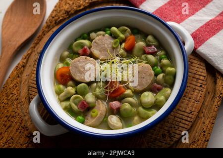 Bean stew with ham and black pudding. Traditional Spanish tapa recipe. Stock Photo