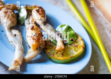 Singapore style grilled frog legs. Stock Photo