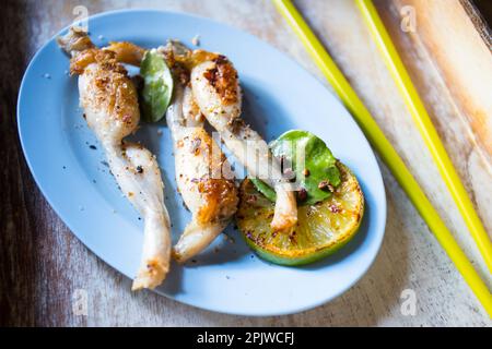 Singapore style grilled frog legs. Stock Photo